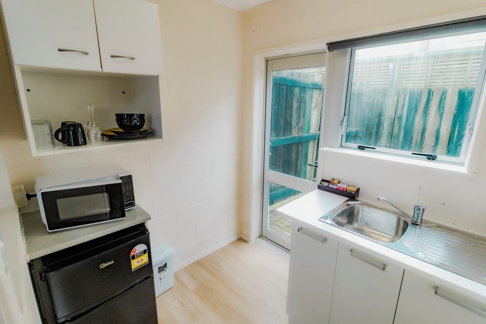 Mini-fridge, microwave, electric kettle, cookware/dishes/utensils