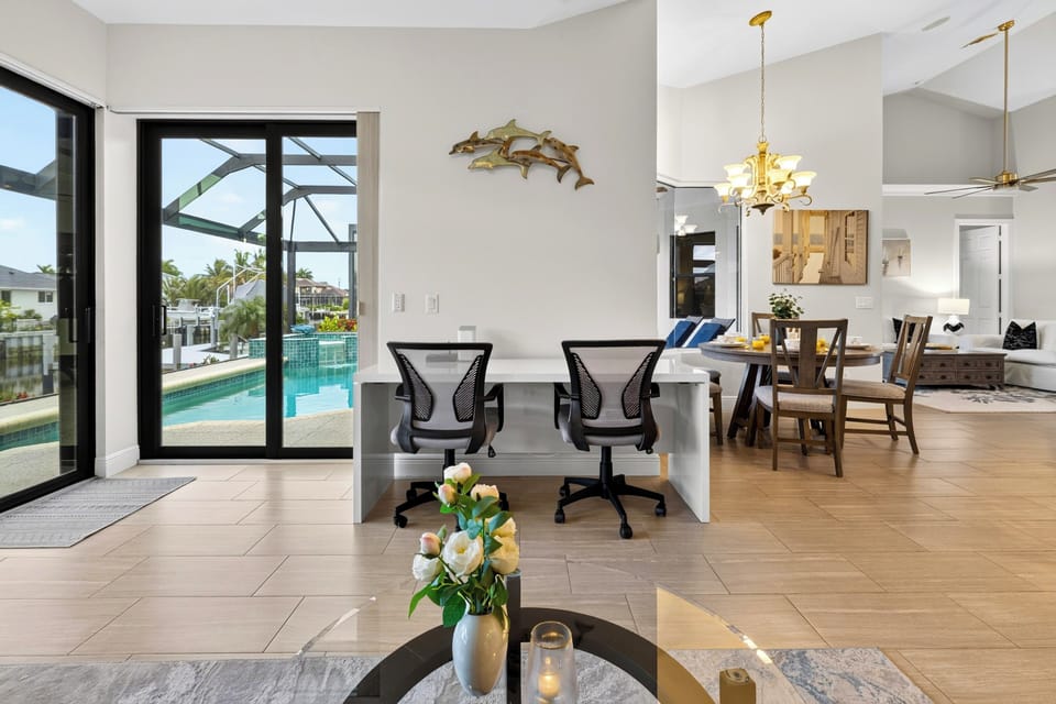 Multi-functional home office nook or tech station positioned conveniently near the main living area with a view of the pool.