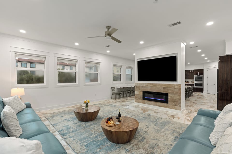 Elegant living room centered around a modern fireplace and large flat-screen TV.