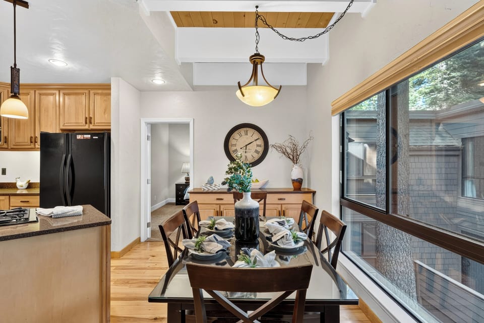 The dedicated dining space provides a comfortable setting for family meals, complete with large windows for natural light.
