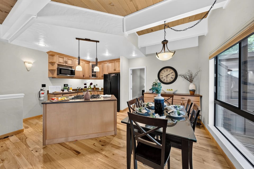 This perspective highlights the proximity of the dining area to the fully equipped kitchen island.