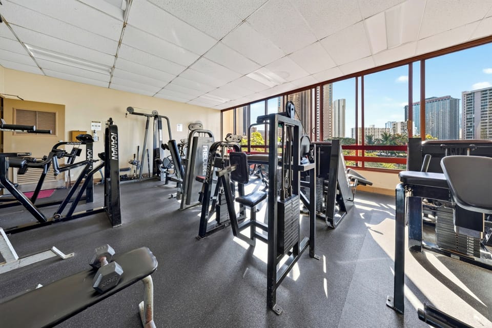 Comprehensive fitness room featuring multiple exercise stations for a full-body workout.