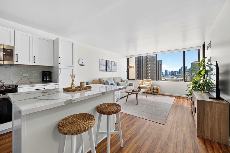 The open floor plan beautifully flows from the modern kitchen island straight into the panoramic living area.