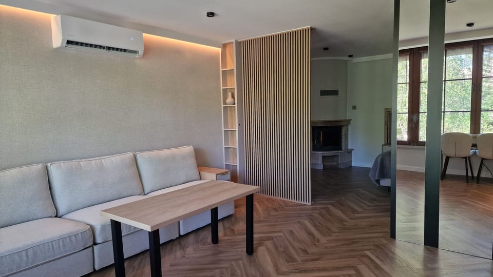 Exclusive Apartment, Garden View | Living area | 32-inch Smart TV with cable channels