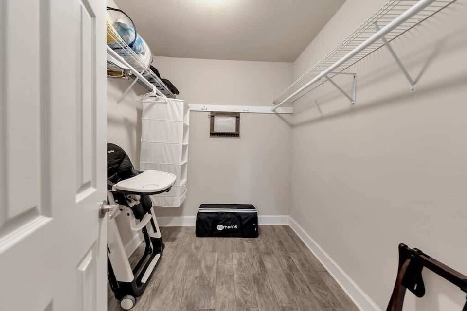 Primary Suite Large Walk-In Closet w/ High Chair & Pack N Play for Families.