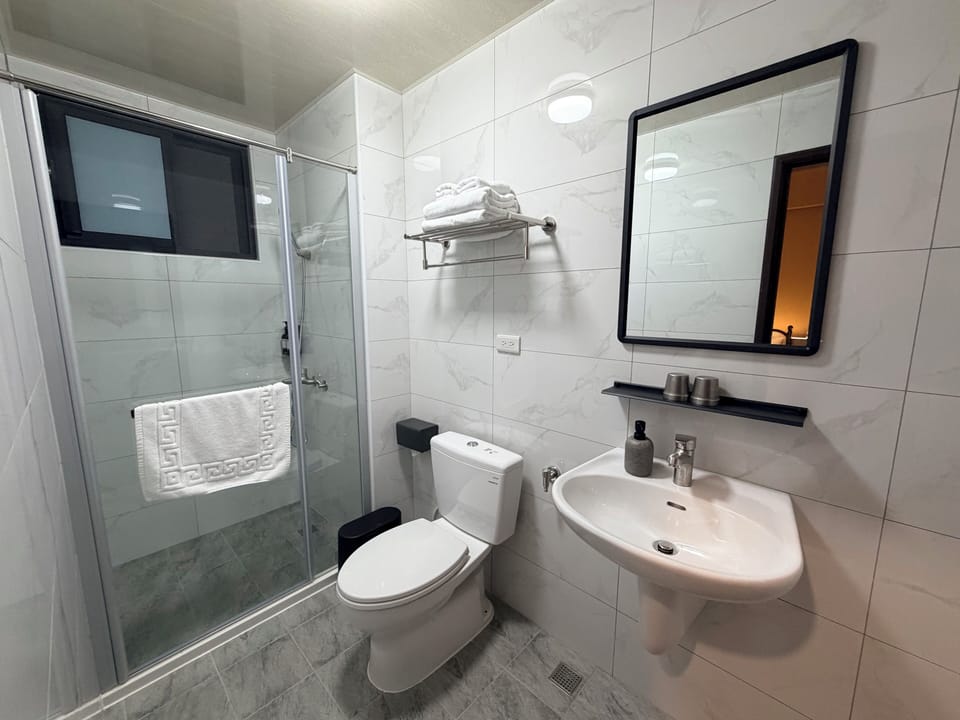 Shower, hair dryer, slippers, towels