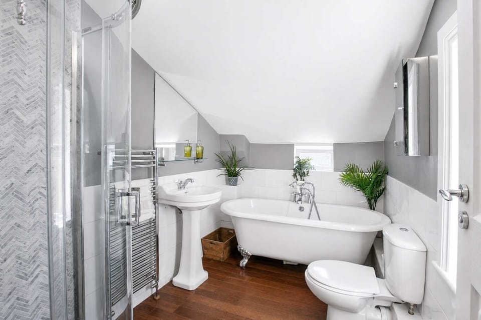 Luxurious Bathroom: Soak in the elegant clawfoot tub or refresh under the sleek walk-in shower!