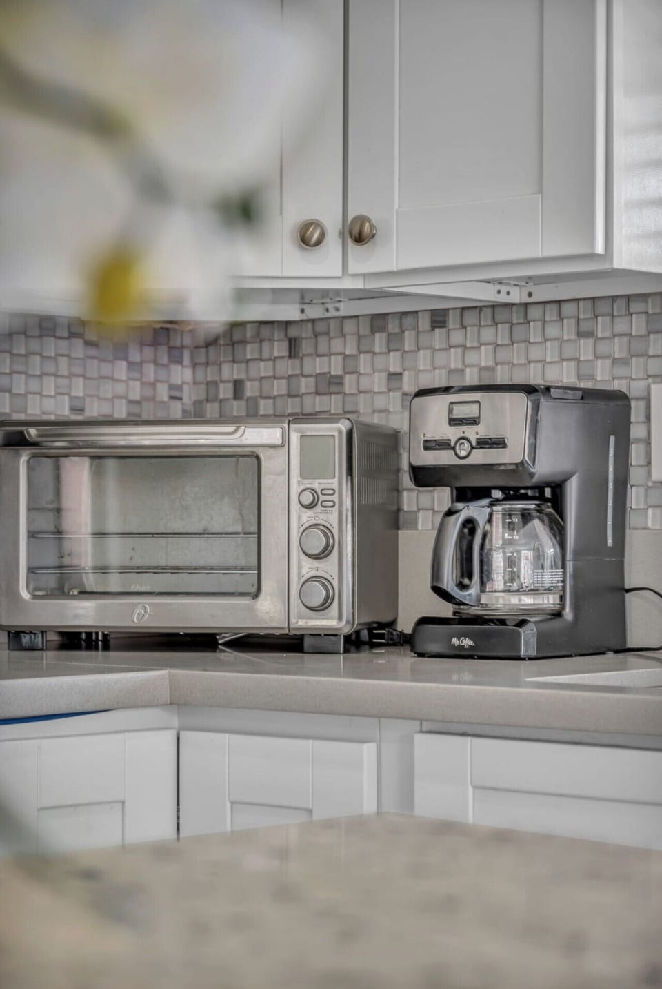 A full kitchen with counter seating includes a fridge, microwave, gas stove, and all of the dishes, drinkware, and utensils you`ll need to make meals or drinks.