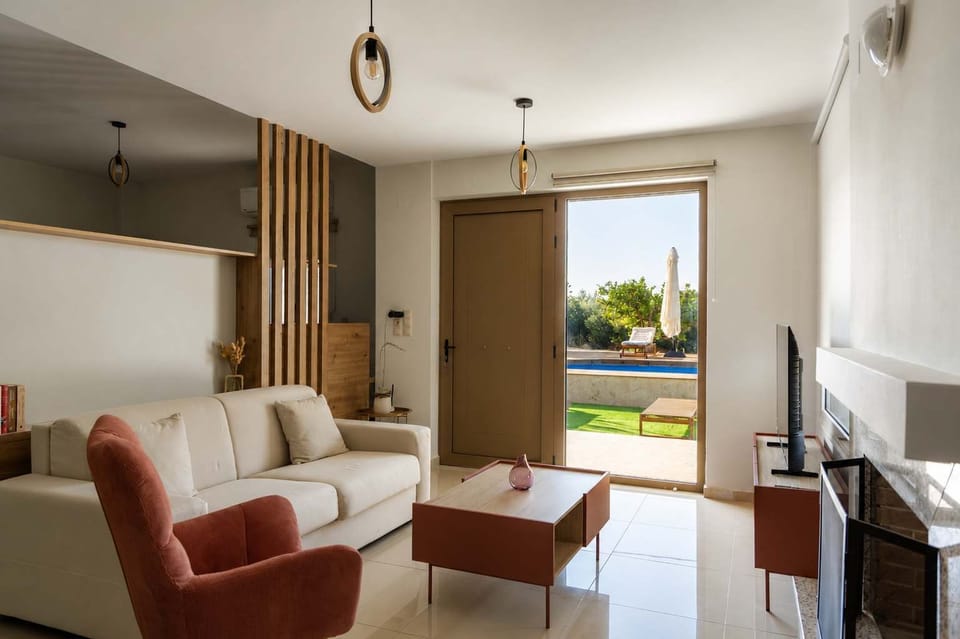 Bright living area with comfortable seating and garden views.