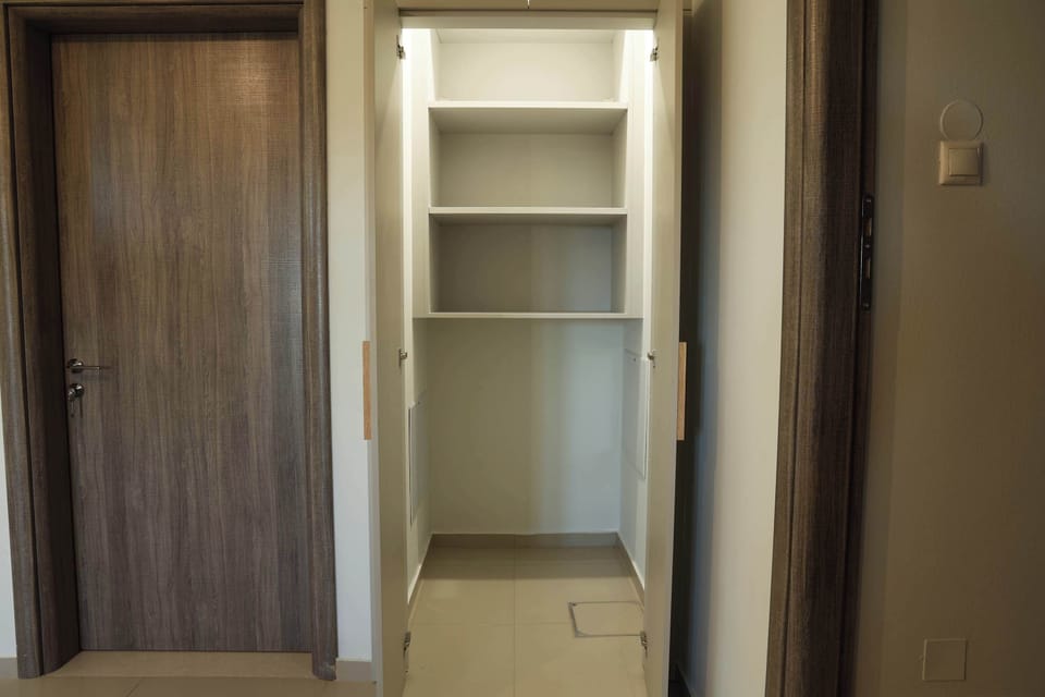 Bedroom storage area with access toward the bathroom.