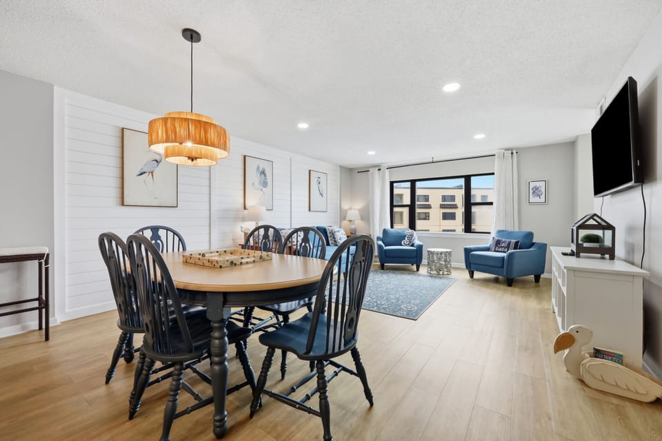 Gather around the dining table or relax in the cozy living area—this open, sunlit space invites you to unwind, share meals, and make memories together in comfort and style.