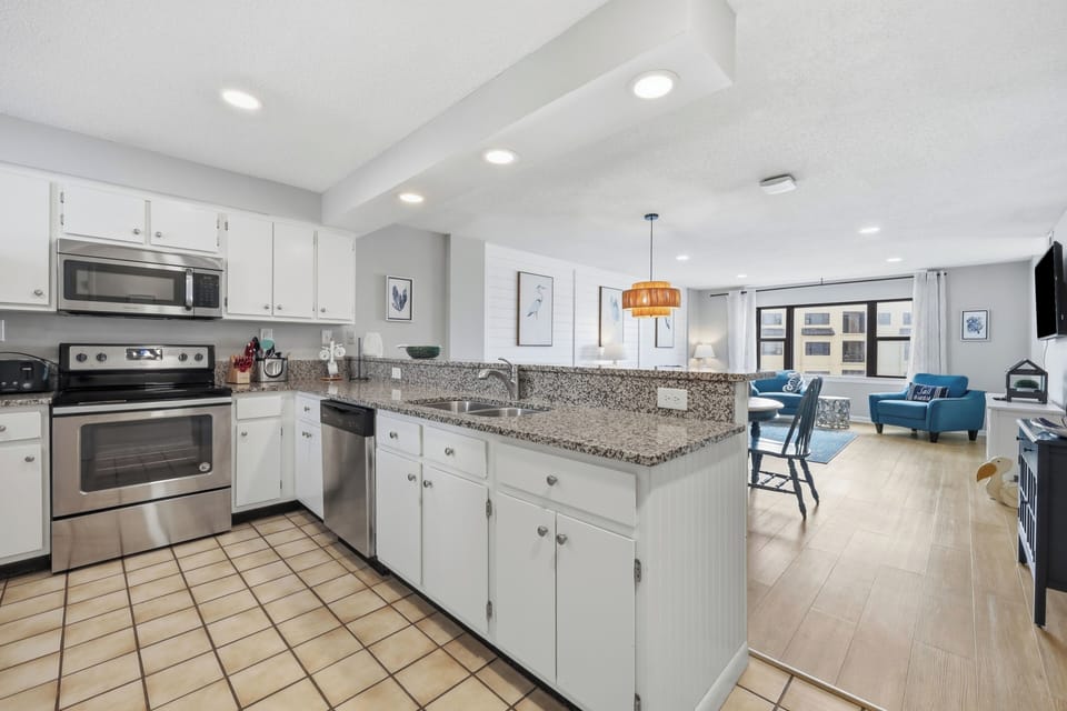 Bright open-concept space where your fully-equipped kitchen flows seamlessly into the living area—perfect for cooking, relaxing, and soaking in natural light.