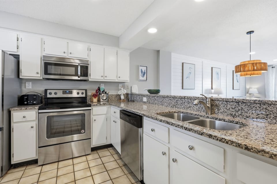 Your fully equipped kitchen features granite countertops, stainless steel appliances, and everything you need to prepare meals during your stay.
