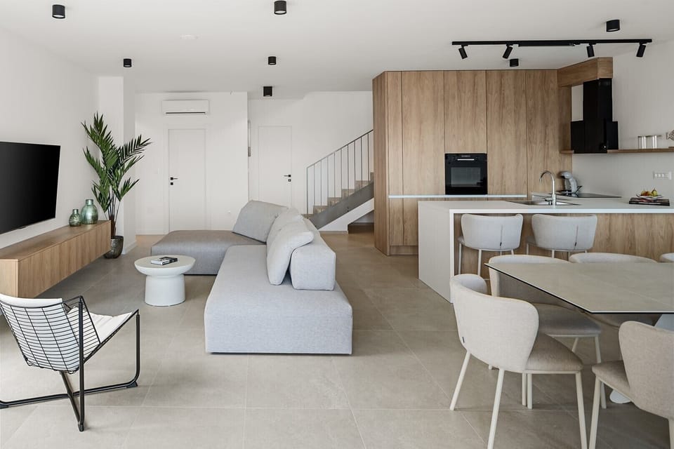 Lounge area features a cozy sofa and a large flat-screen TV.