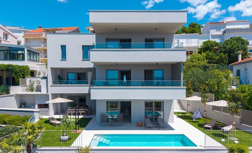 The property accommodates up to 12 guests with a spacious 6-bedroom, 6-bathroom layout.