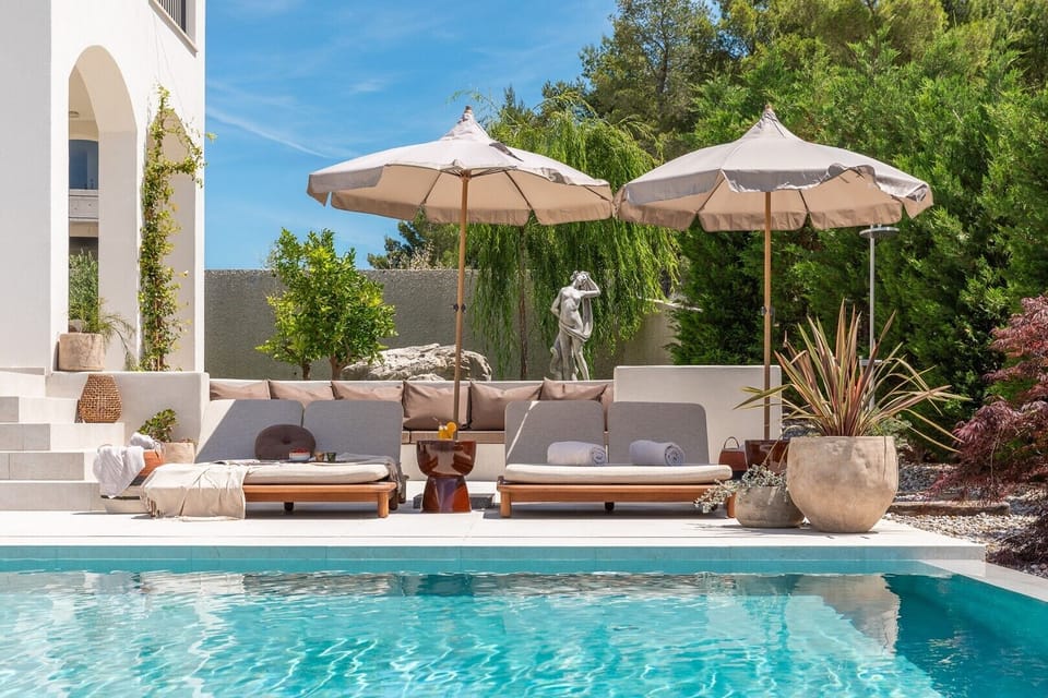 The outdoor area is a private oasis featuring a 52-square-meter heated pool equipped with a hydromassage section and a fully automated salt electrolysis system