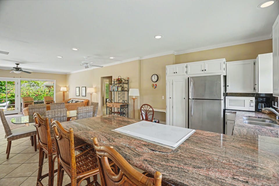 Your open-concept kitchen flows seamlessly into the dining and living areas, creating a welcoming space where you can cook, dine, and relax together with loved ones.