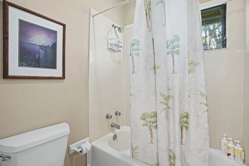 Step into your private bathroom where tropical-themed details and natural light create a refreshing retreat after a day exploring the island.