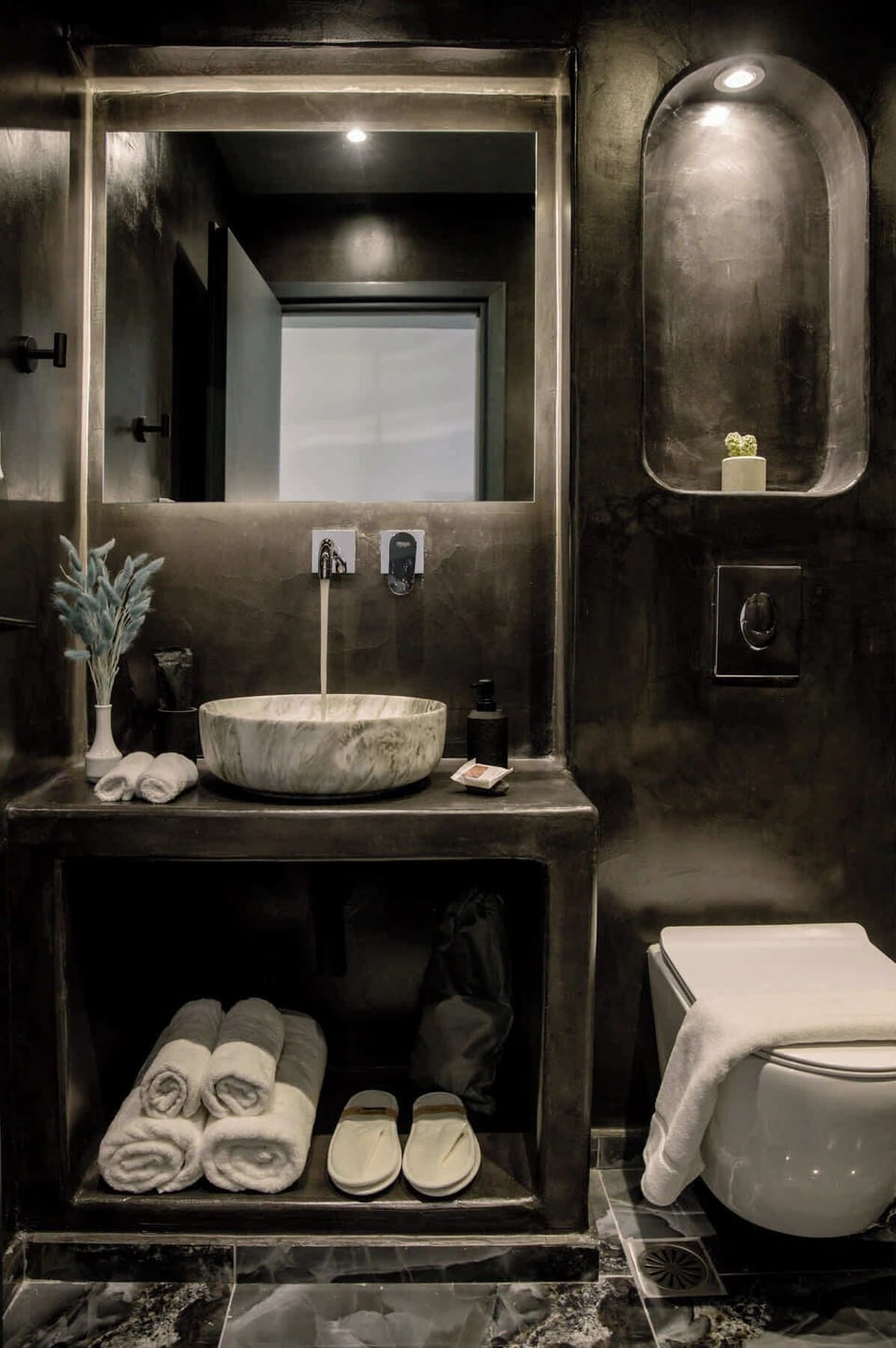 Modern bathroom with elegant finishes and fresh towel amenities.