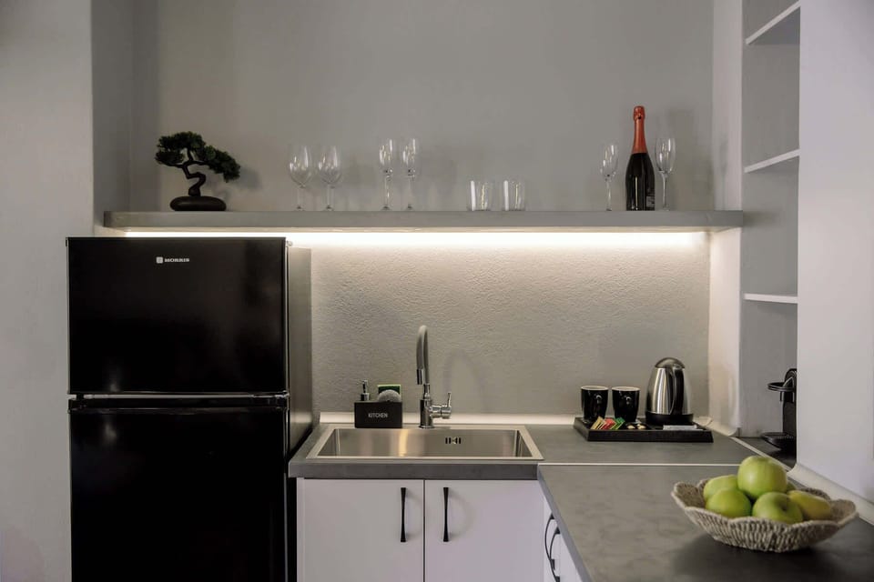 Compact kitchenette corner with coffee essentials.