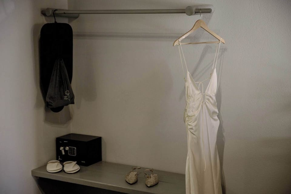 Thoughtful dressing area with hanging space and curated decorative details.