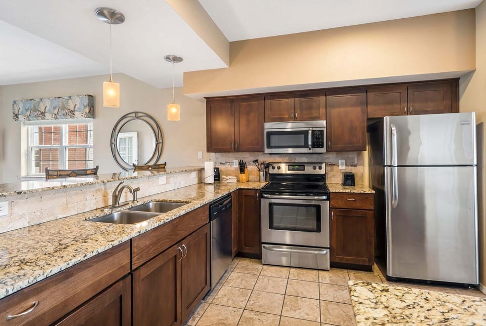 Fully equipped kitchen with upgraded appliances and additional seating at the counter