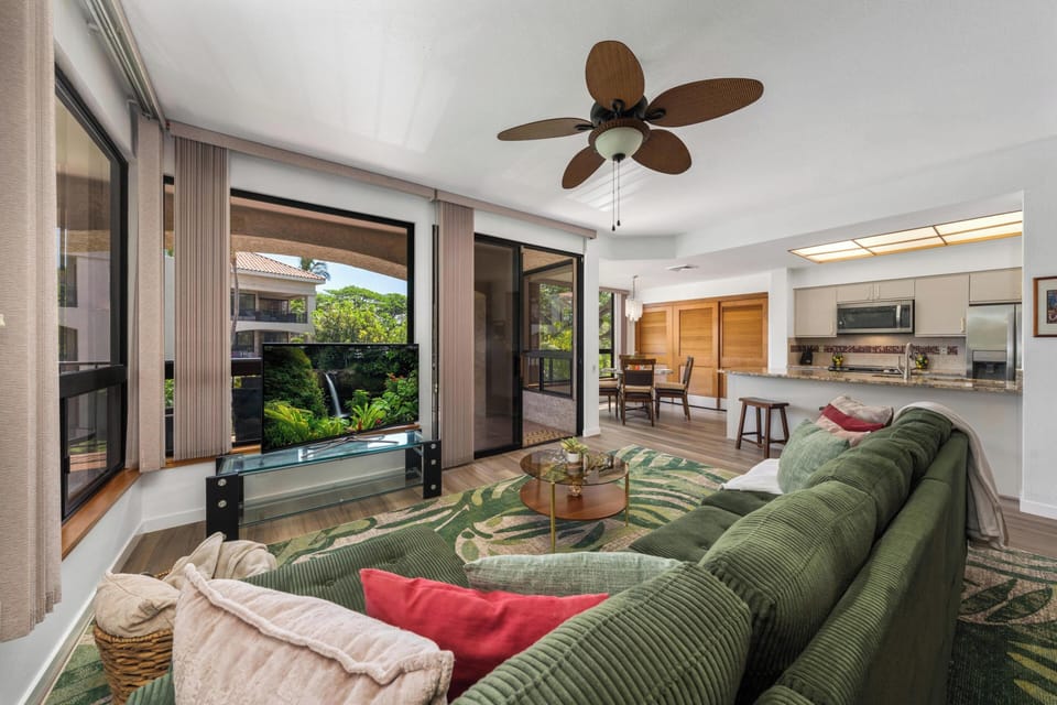 Sink into plush seating and feel the tropical breeze drift through open doors to your private garden oasis. Your open-concept retreat blends comfort with modern style, perfect for unwinding after sun-soaked adventures.