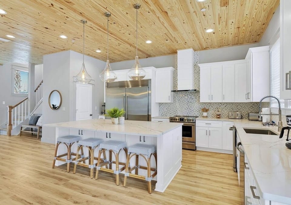 1st Floor - Fully stocked gourmet chef’s kitchen featuring a commercial-size refrigerator, gas range, oversized island, and everything needed to prepare meals for large groups. The heart of the home for cooking, gathering, and entertaining.