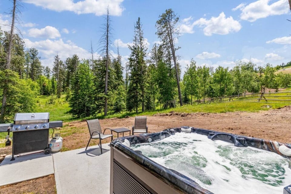 Unwind in the fresh mountain air while soaking in the hot tub and firing up the grill, surrounded by breathtaking scenic views and peaceful nature.