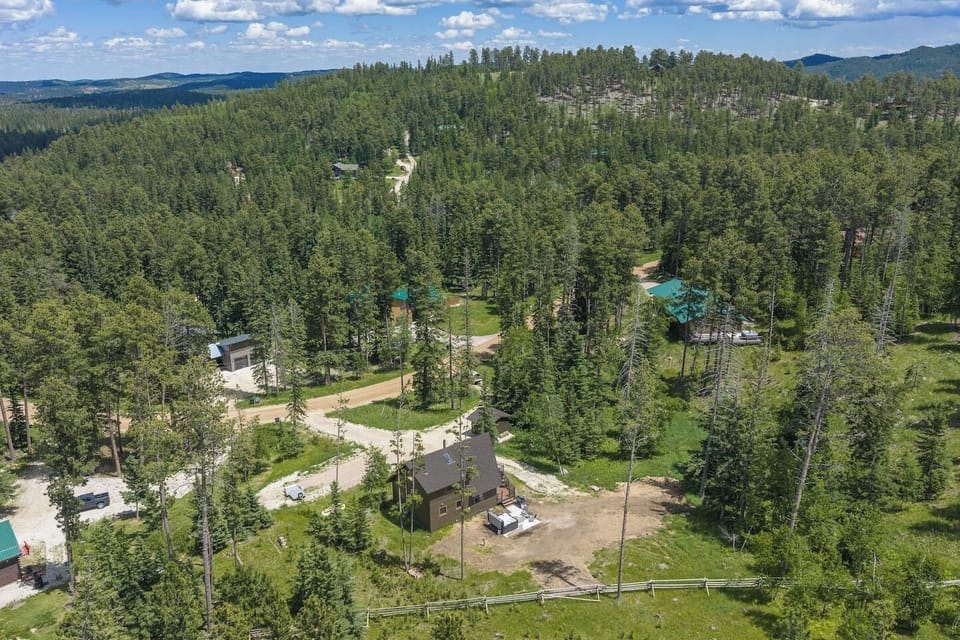 Another aerial angle showcasing the home and its surrounding area, offering a broader perspective of the property`s location and nearby scenery.