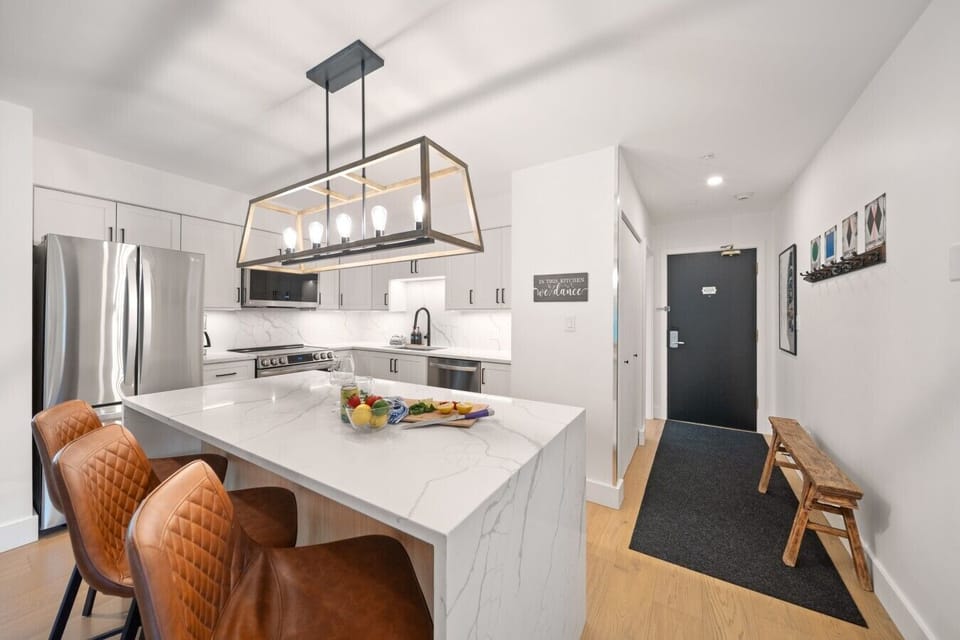 Large kitchen island with bar seating makes an easy gathering spot for morning coffee.