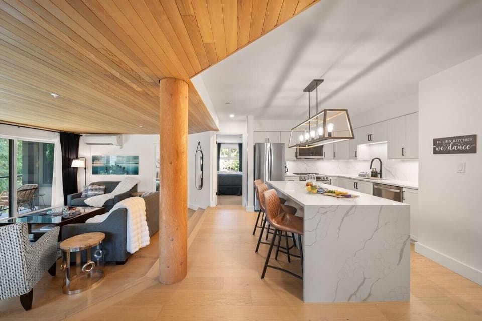 Spacious open kitchen with island seating, flowing seamlessly into the living area.