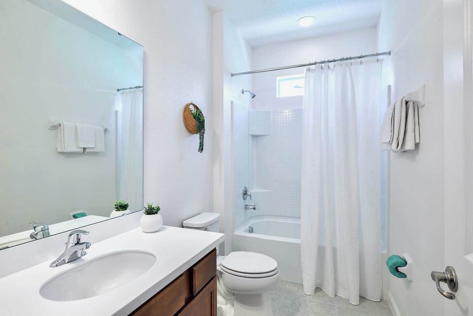 Bright And Spacious Bathroom Featuring A Double Vanity And Elegant Décor