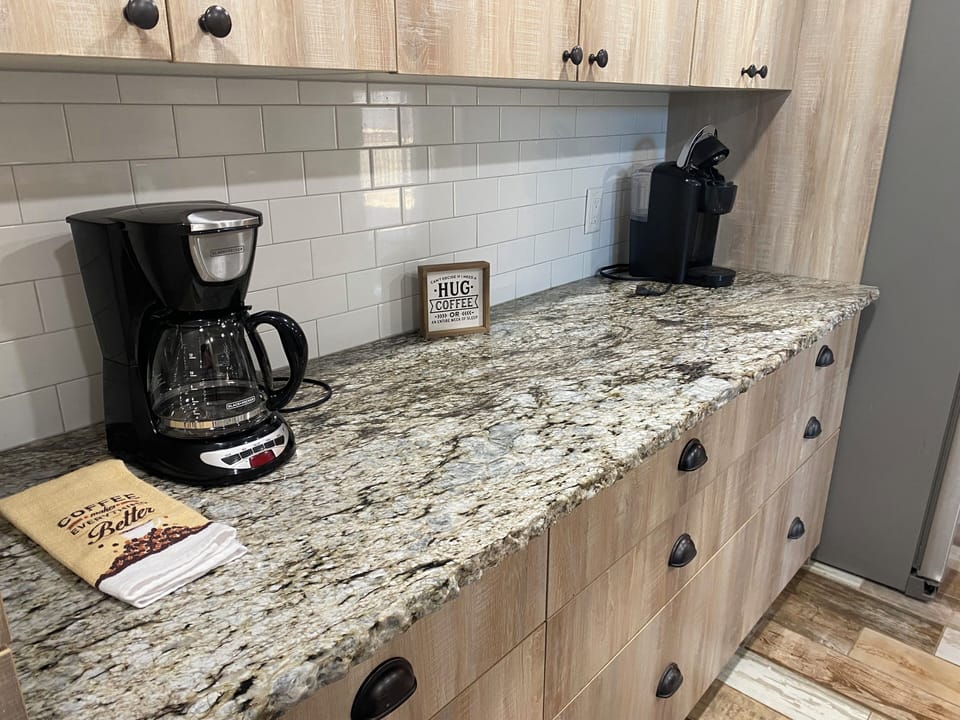 Kitchen, coffee machines, dishes and pans in cabinets, k cups and ground coffee 