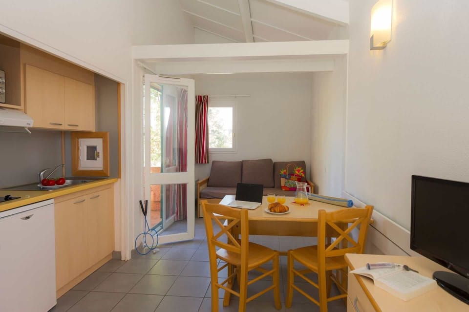 The open-plan living area and kitchenette, with glass doors opening directly onto the private terrace.