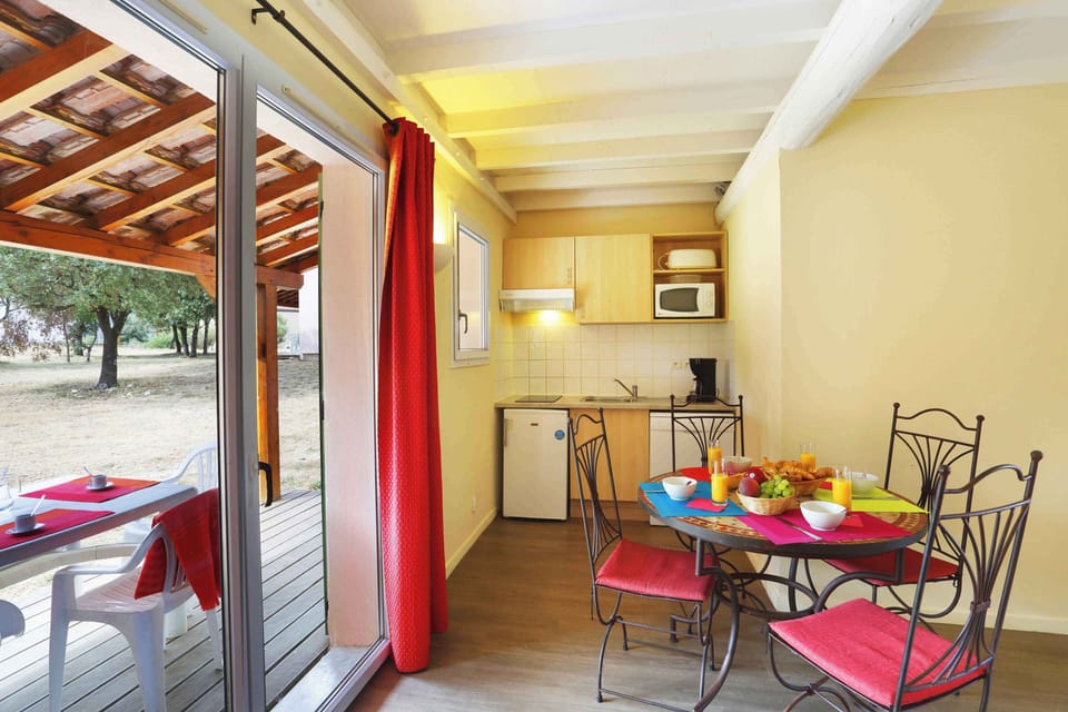 Step straight from the kitchen onto the covered terrace — ideal for morning coffee or evening meals in the warm Languedoc air.