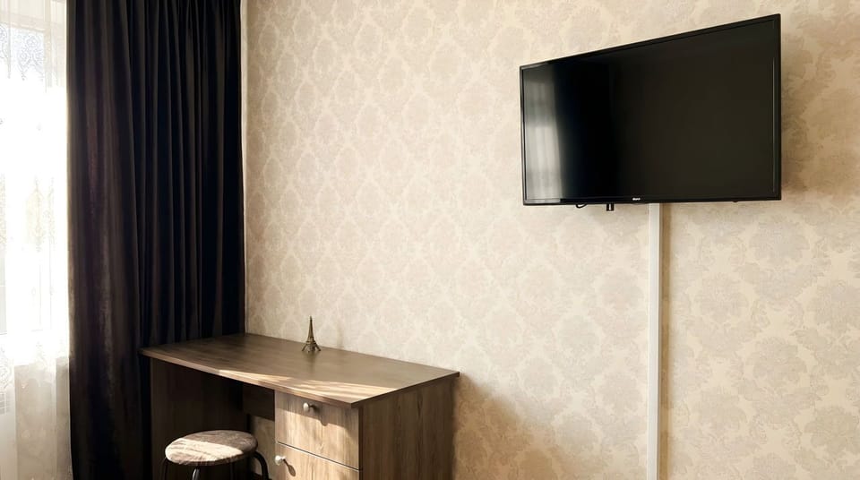 Dedicated workspace with its own work desk, A Smart TV and power socket is near.