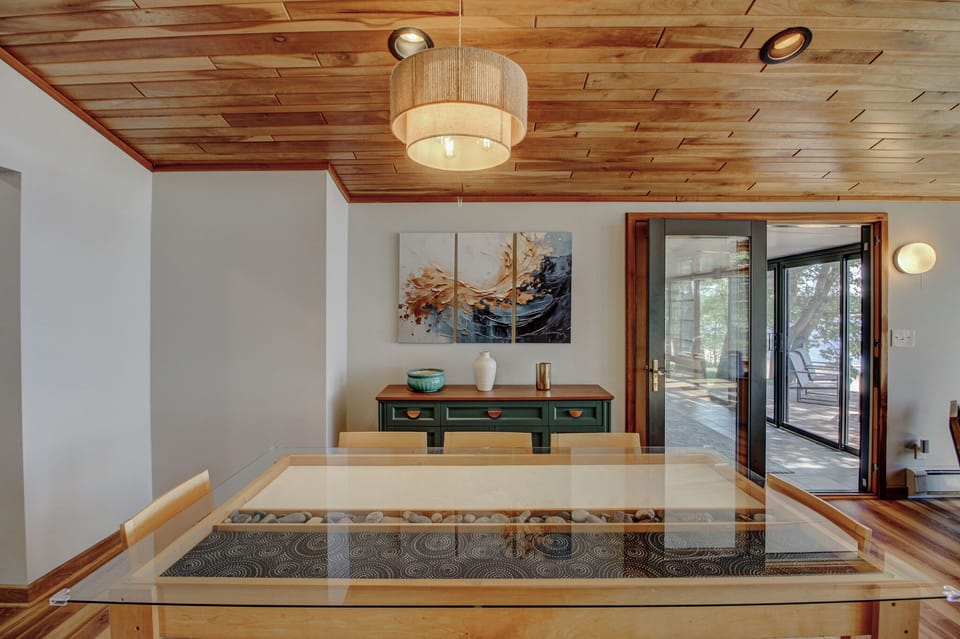 A handcrafted dining table with a river-rock inlay — one of the cabin's many custom touches.
