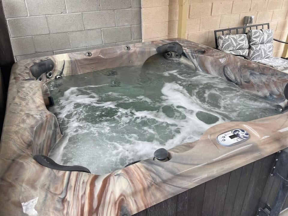 Relax in the backyard's comfortable, separate above-ground spa/hot tub, which is complimentary for all guests to enjoy during your stay.