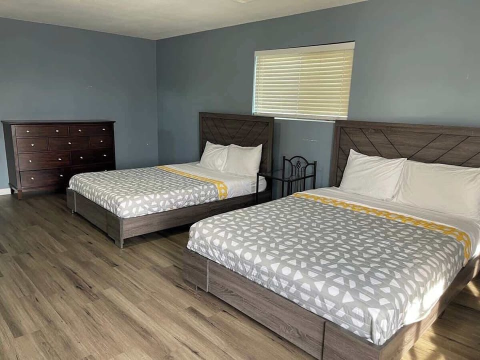 Relax and unwind in this spacious room featuring two queen beds, a private bathroom, and a TV.
