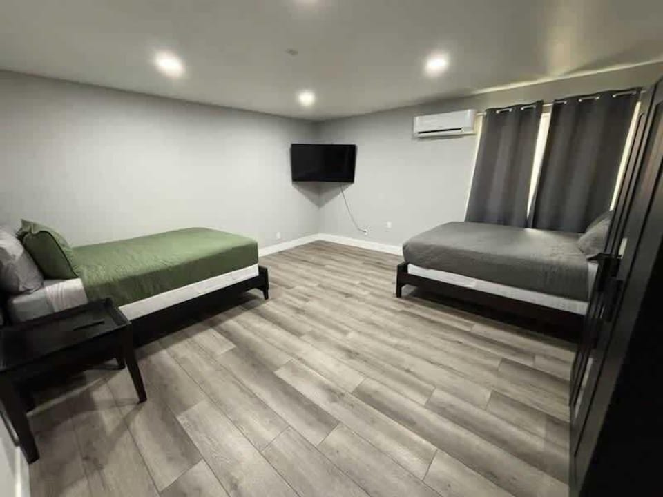 Bright space with two Queen beds, a mini-split AC, and a TV. Located just after the laundry room.