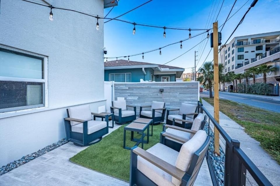 Unwind on cushioned lounge seating under twinkling string lights.