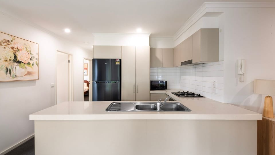 Modern kitchen with stone benchtops and quality appliances