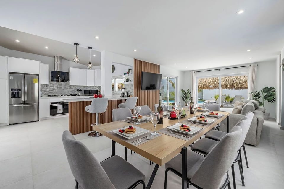 Vacation is all about coming together, and this dining space is perfect for it. Enjoy shared meals before the beach or relaxed dinners at night in this open-concept layout.