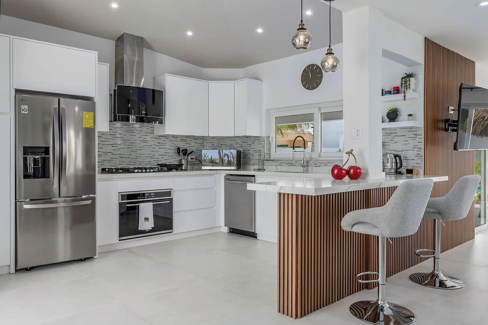 They say the kitchen is the heart of the home, and this one is ready to welcome you! Whether you love cooking full family feasts or just want a sleek space to brew your morning coffee and shake up some sunset cocktails, this kitchen has it all.