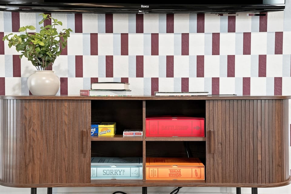 Stylish media console with Roku TV and board games for cozy nights in