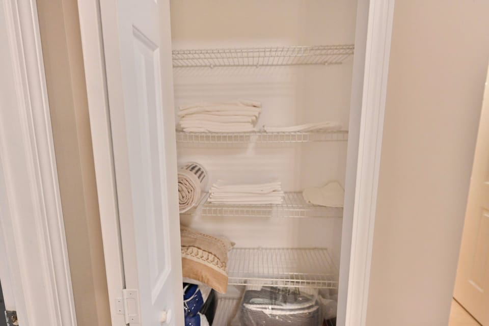 Fresh towels, extra linens, and essentials are neatly stocked for your comfort.