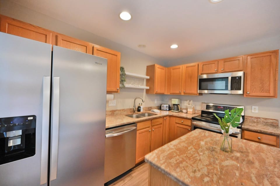Spacious kitchen featuring a central island bar.