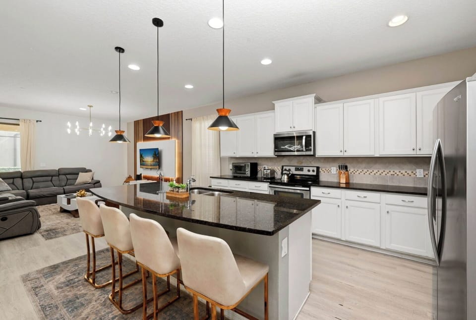 Kitchen: Sleek design meets comfort with modern appliances and stylish seating for memorable meals!