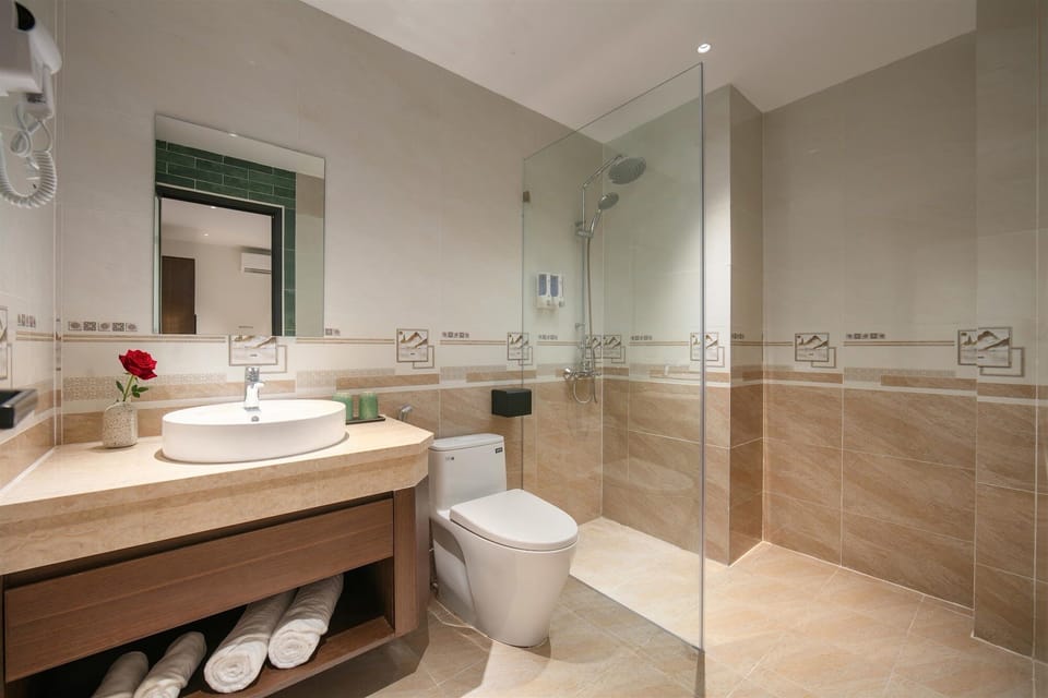 Shower, hair dryer, slippers, towels
